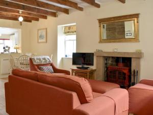 a living room with a couch and a fireplace at Felicity House in Staithes