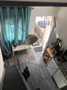 an overhead view of a staircase in a bathroom with a blue shower curtain at Appartement/studio in Bétheny