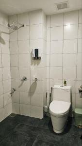 a bathroom with a toilet and a shower stall at KLCC view Balcony 4pax Chambers Suites KL City in Kuala Lumpur