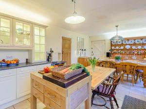 a kitchen with a table with a basket of vegetables on it at Brandon in Sutton on Sea