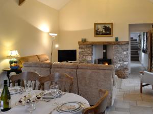 a living room with a couch and a fireplace at The Old Byre in Rhossili