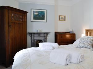 a bedroom with a bed with towels on it at The Mill House, The Square in Talgarth
