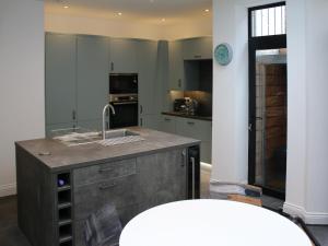 a kitchen with a sink and a counter top at Bay House in Hastings