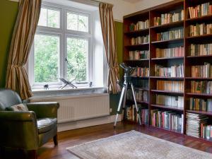 a living room with a window and book shelves filled with books at Trevene in Buttermere