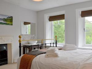 a white bedroom with a bed and a sink at Trevene in Buttermere