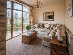 a living room with a couch and a table at Sycamore Barn - Uk33353 in Buttershaw