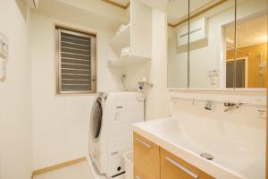 a bathroom with a sink and a washing machine at Hotaku House Akihabara #HO1 in Tokyo +32 photos