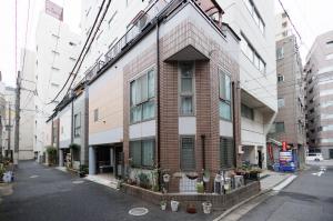 a tall brick building on a city street at Hotaku House Akihabara #HO1 in Tokyo
