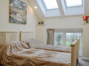 a bedroom with a large bed with a large window at Dutch Barn One - Uk12872 in Brynkir