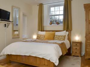 a bedroom with a bed and a window and a television at Ellerview House in Ambleside