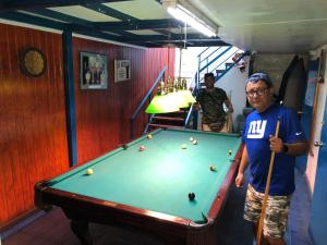 a man standing next to a pool table at Hernanparapente like your home in Iquique