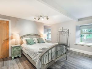 um quarto com uma cama e uma janela em Burnside Cottage em Bardon Mill
