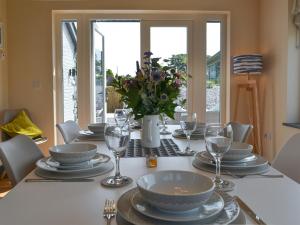 a dining room table with plates and wine glasses at Stabl in Cross Inn