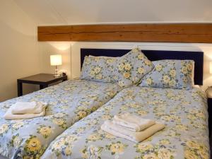 a bedroom with a bed with towels on it at Drift In in Yapton