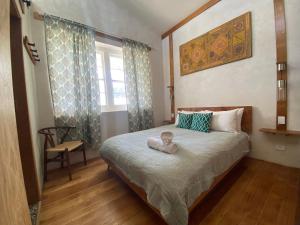 a bedroom with a bed with a stuffed animal on it at The Green House Dening Street Robe in Robe