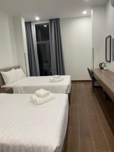 two beds in a hotel room with towels on them at Best Hotel in Ho Chi Minh City