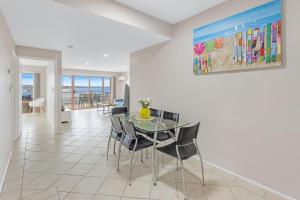 a dining room with a table and chairs and a painting at Jervis Bay Vista in Huskisson