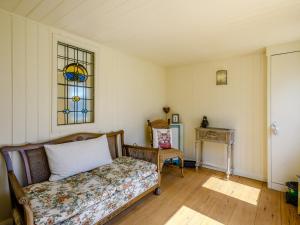 a bedroom with a bed and a stained glass window at Holly Lodge in Hemsby