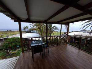 a porch with a table and chairs and the ocean at Hostal Vieroto in Hanga Roa