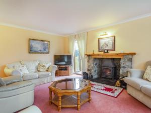 a living room with a couch and a fireplace at Bidean Lodge in Glencoe