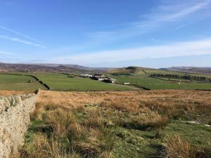 a view from the top of a hill with a stone wall at The Hayloft in Glossop