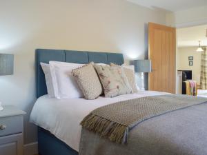 a bedroom with a large bed with pillows at The Retreat - Uk33306 in Hayscastle