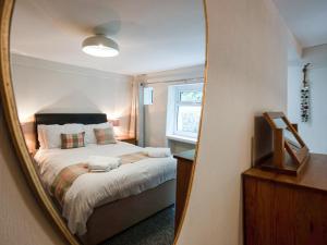 a bedroom with a bed in a mirror at Frondeg in Aberaeron