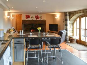 a kitchen with a table and chairs and a fireplace at The Arches - Uk3223 in Linden