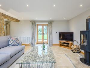 a living room with a couch and a tv at The Granary in Hough on the Hill