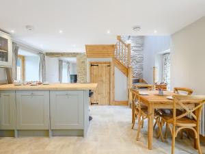 a kitchen and dining room with a table and chairs at The Granary in Hough on the Hill