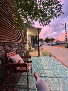 a person with their feet up on the porch of a house at Surfers Paradise Beach House in Herzelia 