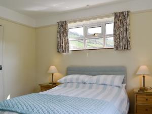 a bedroom with a bed and a window at Valley View-e1866 in Powerstock