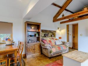 a living room with a couch and a table at Preston Mill Barn in Wensley