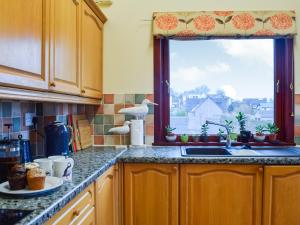 a kitchen with a sink and a window at Braeside House in Tobermory