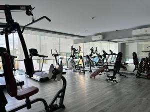 a gym with a bunch of treadmills and exercise bikes at Erawan condo in Chiang Mai