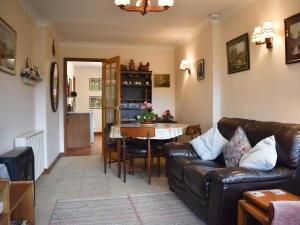 a living room with a couch and a table at Mill Cottage, Marsh Mills in Aveton Gifford
