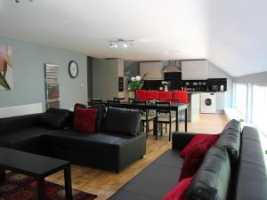 a living room with a couch and a dining room at Riverside Penthouse - Uk31551 in Matlock