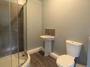 a bathroom with a toilet and a sink and a shower at Riverside Penthouse - Uk31551 in Matlock