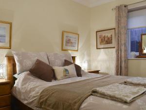 a bedroom with a bed with pillows and a window at Sea Views no, 38 in Cayton