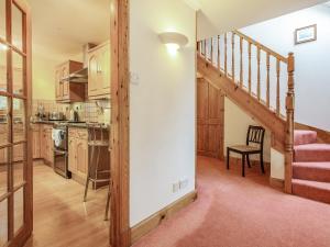 a kitchen with a staircase leading into a living room at Bidean Lodge in Glencoe