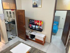 a living room with a flat screen tv on a wall at BlissNest in Dar es Salaam