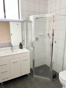 a bathroom with a shower and a sink and a toilet at Harbour View Motel in Robe