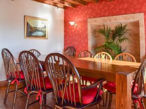 a dining room with a wooden table and chairs at Broadmeadows Farm in Butterton