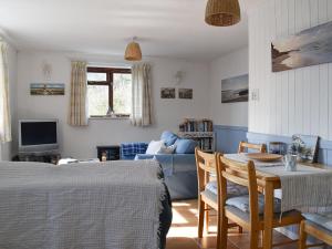 a living room with two beds and a table and a couch at Sea View - Uk30589 in Polperro