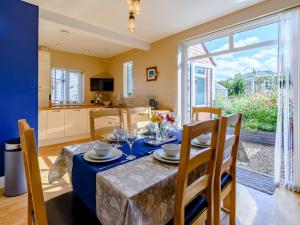 a dining room and kitchen with a table and chairs at Sea Fever in Scarborough