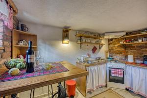 a kitchen with a counter with a bottle of wine at Romantic Haven with Hot Tub - Happy Rentals in Beretinec