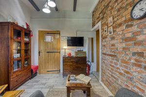 a living room with a brick wall and a table at Romantic Haven with Hot Tub - Happy Rentals in Beretinec