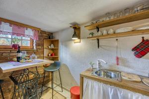 a kitchen with a sink and a counter top at Romantic Haven with Hot Tub - Happy Rentals in Beretinec