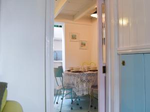 a dining room with a table and chairs in a room at The Cottage in St Ives