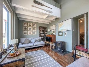 a living room with a couch and a stove at Fishermans Cottage in Gardenstown